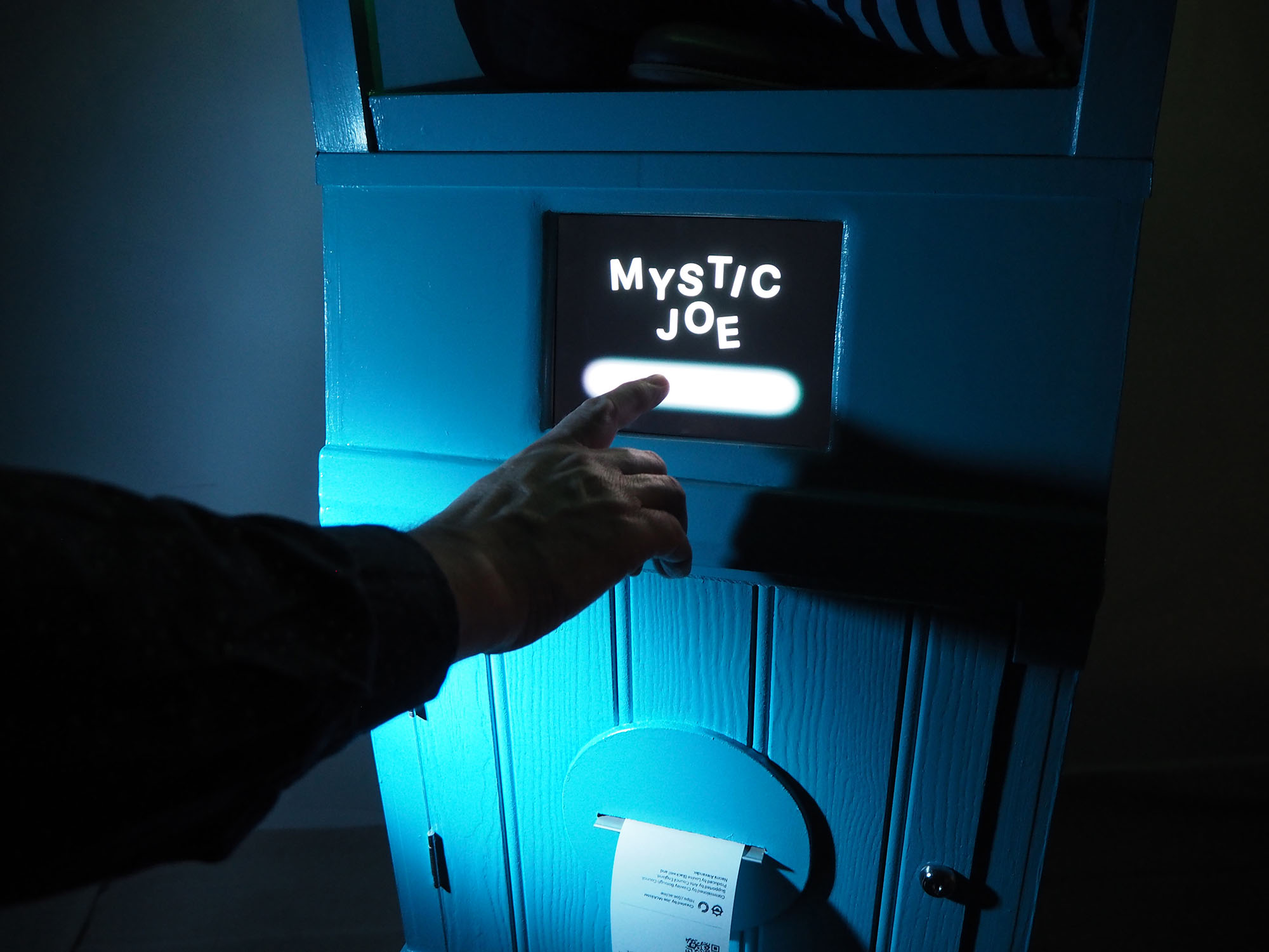 A finger touching an interactive screen